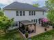 Expansive backyard featuring a pergola with outdoor seating and dining under an umbrella, great for entertaining at 117 Middleton Pl, Mooresville, NC 28117