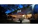 Charming backyard with a pergola-covered seating area and an umbrella table, illuminated for evening relaxation at 117 Middleton Pl, Mooresville, NC 28117
