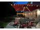 Night shot showcasing the backyard with pergola and dining area lit by string lights at 117 Middleton Pl, Mooresville, NC 28117