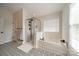 Bathroom with tub, glass enclosed shower, designer floor tile and a double-hung window at 117 Middleton Pl, Mooresville, NC 28117