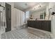 Bathroom featuring dark gray vanity, decorative floor tile and a shower with white shower curtain at 117 Middleton Pl, Mooresville, NC 28117