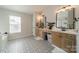 Bathroom features modern fixtures, dual vanity, patterned floors, and a soaking tub at 117 Middleton Pl, Mooresville, NC 28117