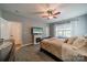 Comfortable bedroom with neutral colors, soft carpet, a ceiling fan, and natural light at 117 Middleton Pl, Mooresville, NC 28117