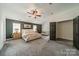 Spacious bedroom features neutral carpet, large windows, and a ceiling fan at 117 Middleton Pl, Mooresville, NC 28117