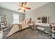 Neutral-toned bedroom with a ceiling fan, makeup vanity, and stylish shelving at 117 Middleton Pl, Mooresville, NC 28117