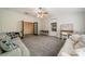 Spacious bonus room featuring plush carpeting, ceiling fan, couches, built-in shelving, and a foosball table at 117 Middleton Pl, Mooresville, NC 28117