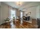 Bright dining room with hardwood floors, modern lighting, and elegant decor at 117 Middleton Pl, Mooresville, NC 28117