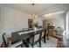 Bright dining room featuring a modern chandelier, wainscoting and hardwood floors at 117 Middleton Pl, Mooresville, NC 28117