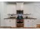 Updated kitchen features stainless steel appliances, subway tile backsplash, and ample cabinet space at 117 Middleton Pl, Mooresville, NC 28117