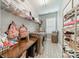 Well-organized laundry room features modern machines, folding table, shelving and patterned tile floors at 117 Middleton Pl, Mooresville, NC 28117