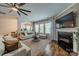 Inviting living room featuring a fireplace, hardwood floors, and large windows at 117 Middleton Pl, Mooresville, NC 28117
