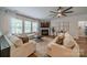 Comfortable living room featuring a fireplace, hardwood floors, and large windows for natural light at 117 Middleton Pl, Mooresville, NC 28117