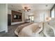 Large bedroom with a ceiling fan and a flat screen tv mounted on a decorative wood accent wall at 117 Middleton Pl, Mooresville, NC 28117