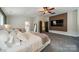 The spacious main bedroom features a sitting area, ensuite bathroom and large flat screen tv at 117 Middleton Pl, Mooresville, NC 28117