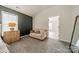 Cozy sitting area in bedroom featuring neutral color scheme and natural light from the large window at 117 Middleton Pl, Mooresville, NC 28117