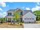 Beautiful two-story home featuring brick and white siding with a well-manicured front yard and a two-car garage at 130 Fordham Ct # 18, Fort Mill, SC 29715
