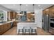 Stylish kitchen with a large island, stainless steel appliances, wooden cabinets, and modern pendant lighting at 130 Fordham Ct # 18, Fort Mill, SC 29715