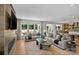 Bright open-concept living room with hardwood floors seamlessly leading to a kitchen and dining area at 130 Fordham Ct # 18, Fort Mill, SC 29715