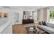 Cozy living room with modern decor, hardwood floors, large windows, and a comfortable couch, creating an inviting space at 130 Fordham Ct # 18, Fort Mill, SC 29715