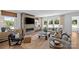 Sunlit living room with modern fireplace, hardwood floors, neutral palette, and views of the outdoors at 130 Fordham Ct # 18, Fort Mill, SC 29715