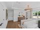 Serene main bedroom with tray ceilings, a decorative chandelier, and hardwood floors, creating a luxurious retreat at 130 Fordham Ct # 18, Fort Mill, SC 29715