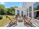 Outdoor patio with Adirondack chairs and a table, surrounded by a well-maintained lawn, perfect for relaxation at 130 Fordham Ct # 18, Fort Mill, SC 29715