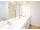 Bright bathroom featuring a long countertop with double sinks and a large mirror at 14849 Santa Lucia Dr, Charlotte, NC 28277