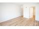 Spacious bedroom featuring hardwood floors, a doorway, and bright natural light at 14849 Santa Lucia Dr, Charlotte, NC 28277
