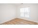 Bright bedroom featuring wood floors and a large window with blinds at 14849 Santa Lucia Dr, Charlotte, NC 28277