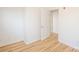 Bedroom featuring wood floors, white walls and a white door at 14849 Santa Lucia Dr, Charlotte, NC 28277