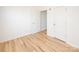 Bright bedroom featuring wood floors and a white door at 14849 Santa Lucia Dr, Charlotte, NC 28277