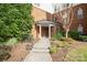 Inviting brick building entrance featuring well-manicured landscaping and clearly marked signage at 14849 Santa Lucia Dr, Charlotte, NC 28277