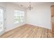 Dining area with large window, chandelier, and hardwood floors at 14849 Santa Lucia Dr, Charlotte, NC 28277