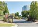 Community entrance featuring brick pillars, iron gates, landscaping and street at 14849 Santa Lucia Dr, Charlotte, NC 28277