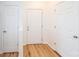 Bright foyer showcasing hardwood floors and multiple interior doors for storage and privacy at 14849 Santa Lucia Dr, Charlotte, NC 28277