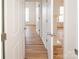 Hallway with hardwood floors leading to other rooms in the house, showcasing the open layout at 14849 Santa Lucia Dr, Charlotte, NC 28277