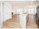 Open-concept kitchen and living area showcasing hardwood floors and modern appliances at 14849 Santa Lucia Dr, Charlotte, NC 28277
