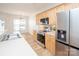 Well-lit kitchen with stainless steel appliances, light wood cabinets, and bright countertops at 14849 Santa Lucia Dr, Charlotte, NC 28277