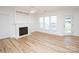 Living room featuring a fireplace, hardwood floors, and natural light at 14849 Santa Lucia Dr, Charlotte, NC 28277