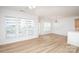 Bright living room featuring hardwood floors, white trim, and large windows with ample natural light at 14849 Santa Lucia Dr, Charlotte, NC 28277