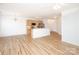 Open living space showcasing hardwood floors and kitchen area at 14849 Santa Lucia Dr, Charlotte, NC 28277