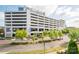 Exterior view of a multi-story parking garage with landscaping at 14849 Santa Lucia Dr, Charlotte, NC 28277