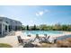 Community pool with lounge chairs and seating areas on a sunny day at 14849 Santa Lucia Dr, Charlotte, NC 28277