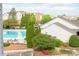 View of the community pool surrounded by trees and landscaping at 14849 Santa Lucia Dr, Charlotte, NC 28277
