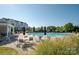 Community pool area featuring lounge chairs, tables, and a well-maintained pool at 14849 Santa Lucia Dr, Charlotte, NC 28277