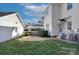 Beautiful backyard featuring a patio area, lush lawn, and manicured hedges at 15236 Waterfront Dr, Huntersville, NC 28078