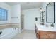 Bathroom with soaking tub, glass shower, dual sinks, and tile flooring at 15236 Waterfront Dr, Huntersville, NC 28078