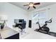 Functional bedroom featuring a ceiling fan, desk with monitors, and a Peloton exercise bike at 15236 Waterfront Dr, Huntersville, NC 28078