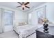 Bright bedroom featuring neutral tones, a ceiling fan, and windows providing natural light at 15236 Waterfront Dr, Huntersville, NC 28078