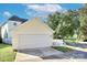 Two car garage with white doors, surrounded by a white picket fence and a well-manicured lawn at 15236 Waterfront Dr, Huntersville, NC 28078